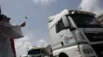 Un cura bendice camiones durante la celebración de San Cristóbal en el puerto de Valencia